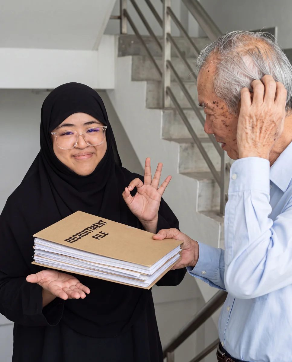 An RREA consultant handing over a recruitment file to a relieved employer