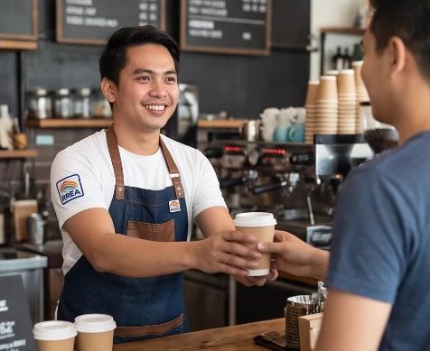 A barista serving a customer