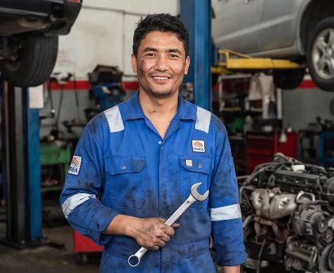 A mechanic working on an engine